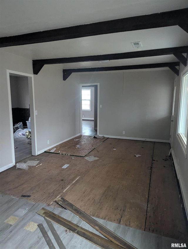 spare room featuring beam ceiling