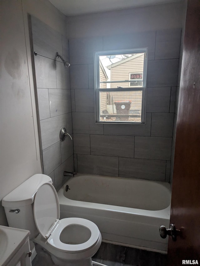 full bathroom featuring vanity, toilet, and tiled shower / bath