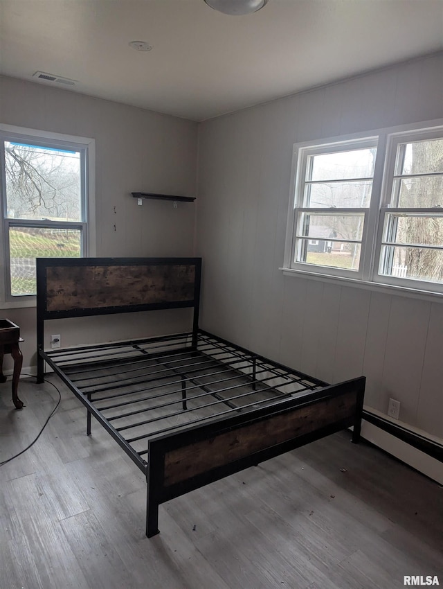 bedroom with hardwood / wood-style flooring