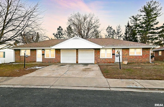 ranch-style house featuring a garage, concrete driveway, and brick siding