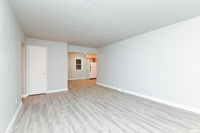 spare room with light hardwood / wood-style flooring