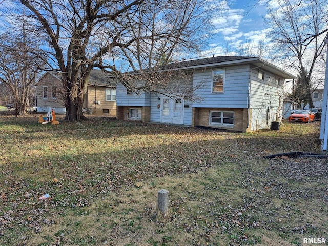 rear view of house with a lawn