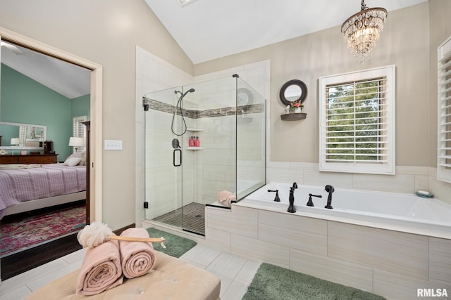 bathroom with a chandelier, independent shower and bath, tile patterned floors, and lofted ceiling