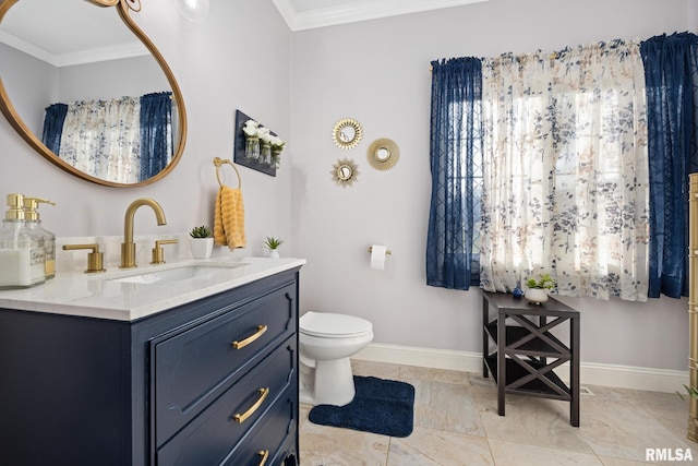 bathroom with vanity, toilet, and ornamental molding