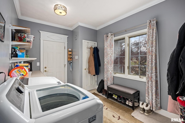 washroom featuring washer and dryer, light carpet, and ornamental molding