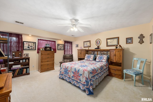 bedroom with ceiling fan and light colored carpet