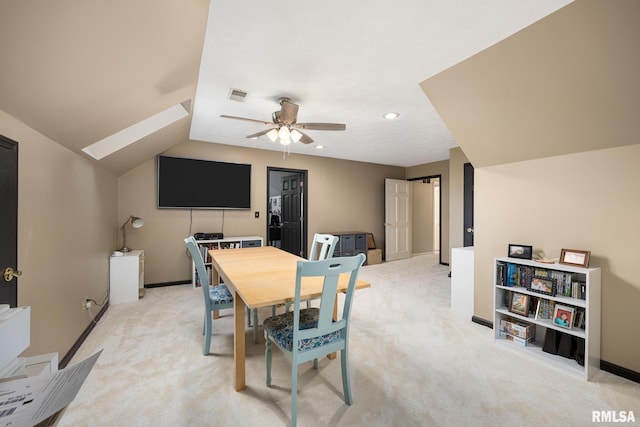 dining space featuring light carpet, ceiling fan, and lofted ceiling