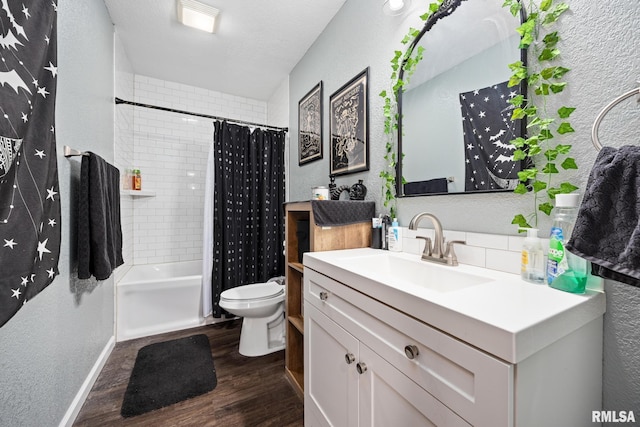 full bathroom featuring wood-type flooring, a textured ceiling, toilet, vanity, and shower / tub combo