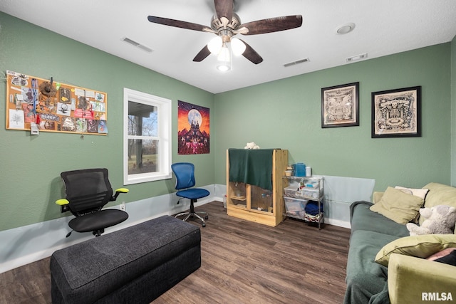 sitting room with dark hardwood / wood-style flooring and ceiling fan