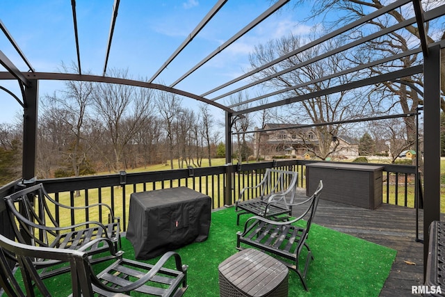 wooden deck featuring area for grilling and a lawn