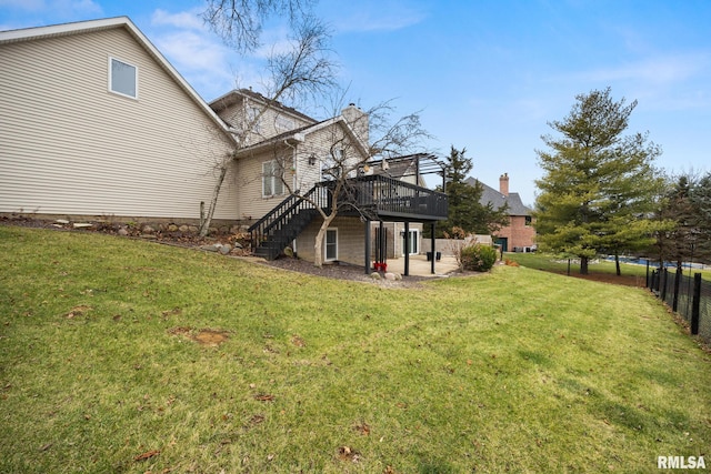 rear view of property with a yard, a patio, and a wooden deck