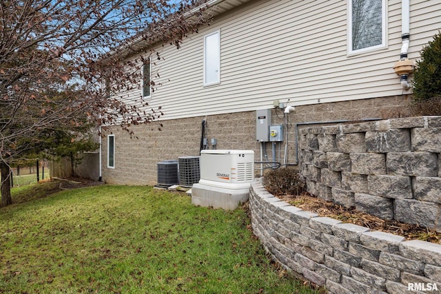 view of home's exterior featuring cooling unit and a lawn