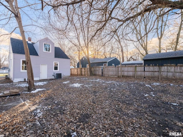 yard at dusk with central AC unit