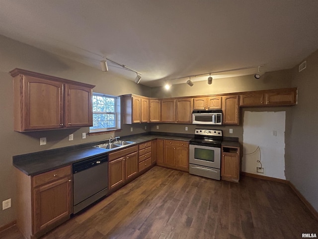 kitchen with sink, dark hardwood / wood-style floors, and appliances with stainless steel finishes