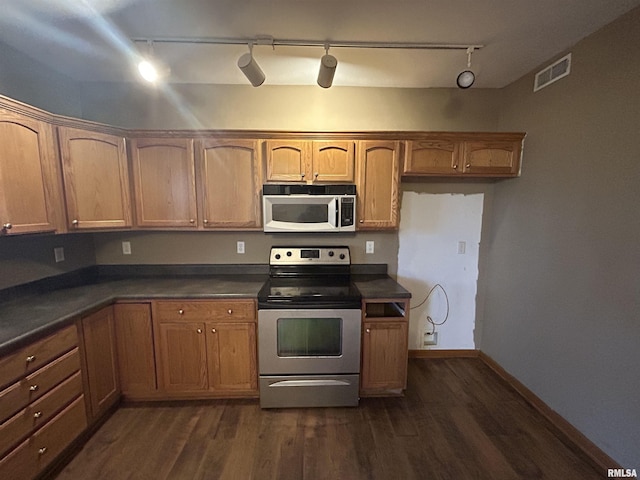 kitchen with dark hardwood / wood-style flooring, stainless steel range with electric cooktop, and track lighting