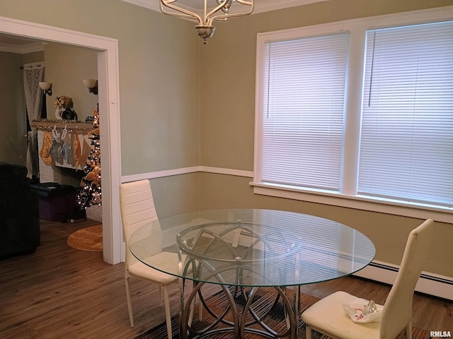 dining space featuring a notable chandelier, dark hardwood / wood-style floors, and ornamental molding