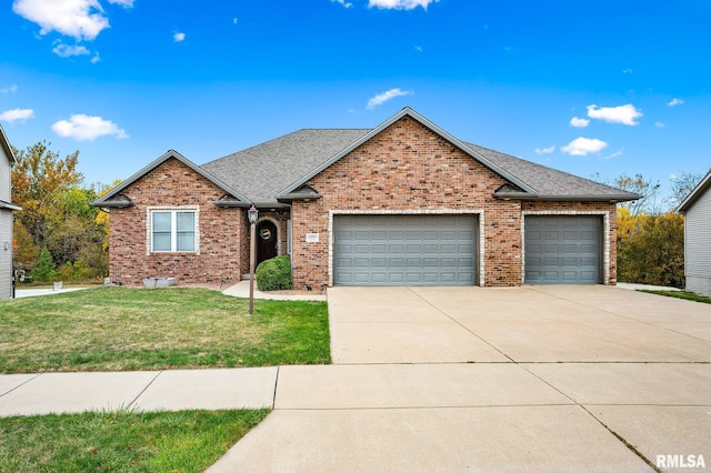 view of front of house featuring a front yard and a garage