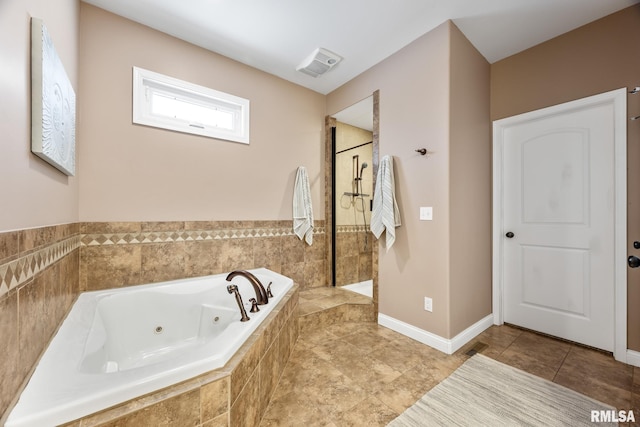 bathroom featuring shower with separate bathtub