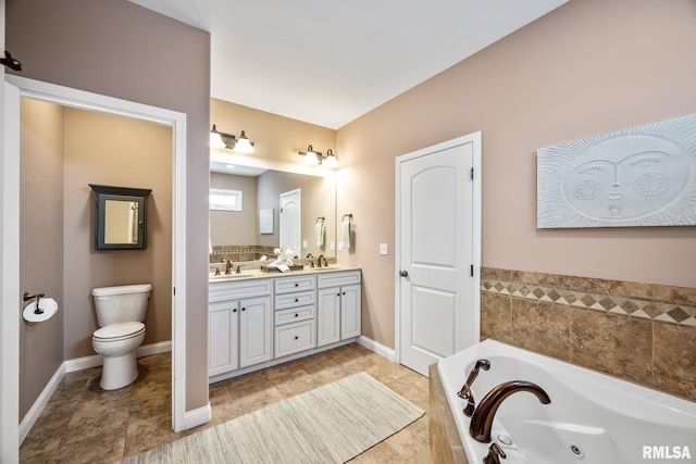 bathroom with vanity, toilet, and tiled tub