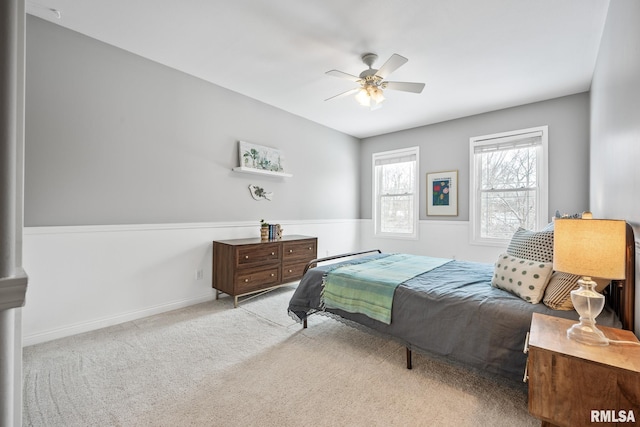 bedroom with ceiling fan and light colored carpet