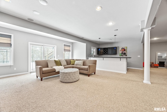 living room with light carpet and decorative columns