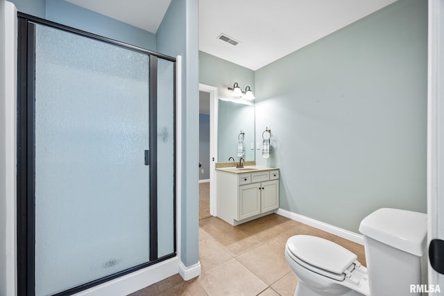 bathroom featuring tile patterned floors, vanity, an enclosed shower, and toilet