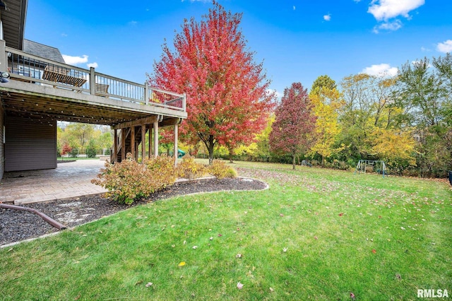 view of yard with a patio area and a wooden deck