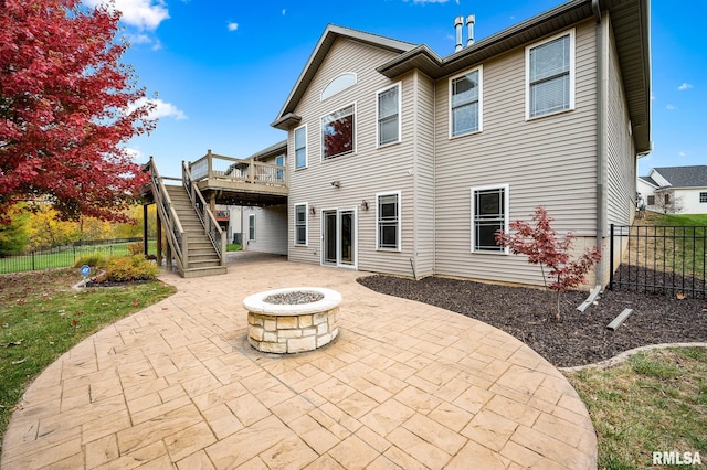 rear view of house featuring a patio area, an outdoor fire pit, and a wooden deck