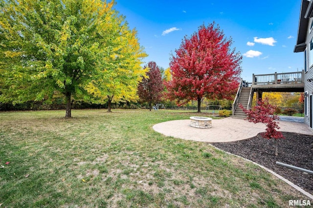 view of yard with a patio area, a deck, and an outdoor fire pit