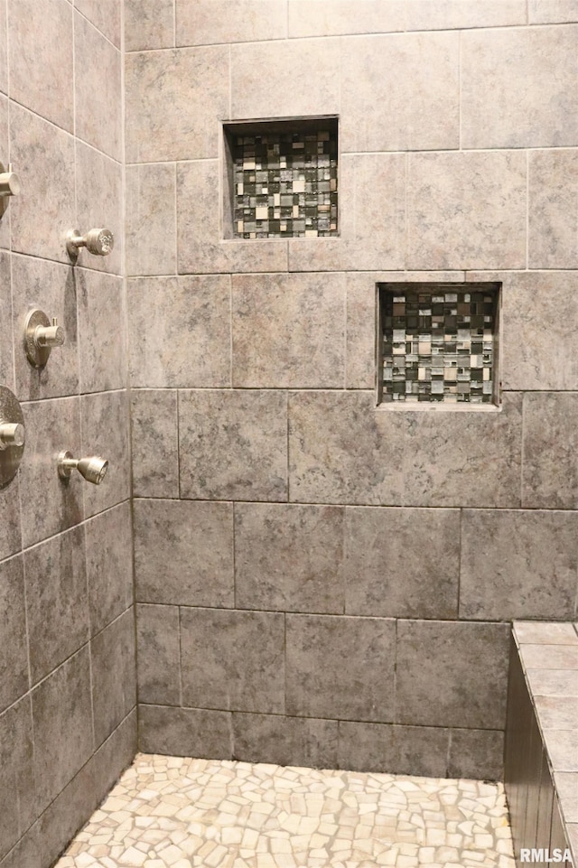 bathroom with tiled shower