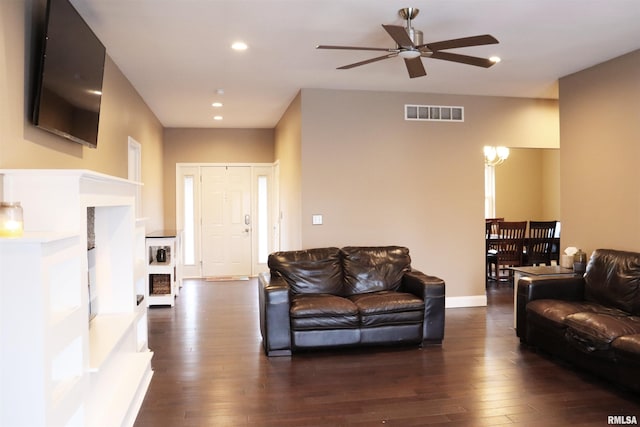 living room featuring ceiling fan and dark hardwood / wood-style floors