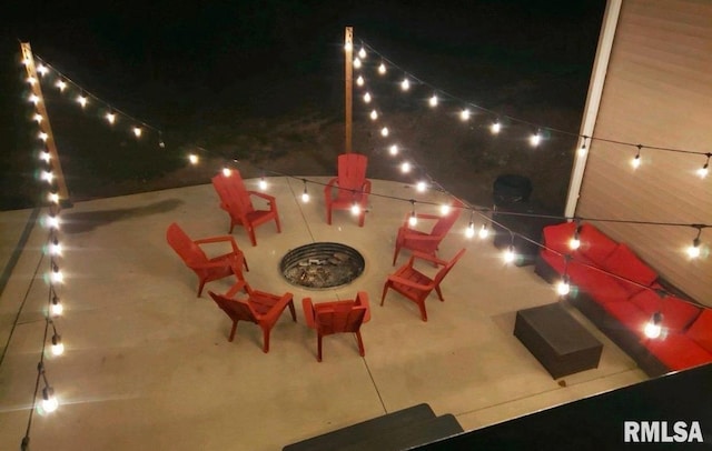 patio at night featuring a fire pit