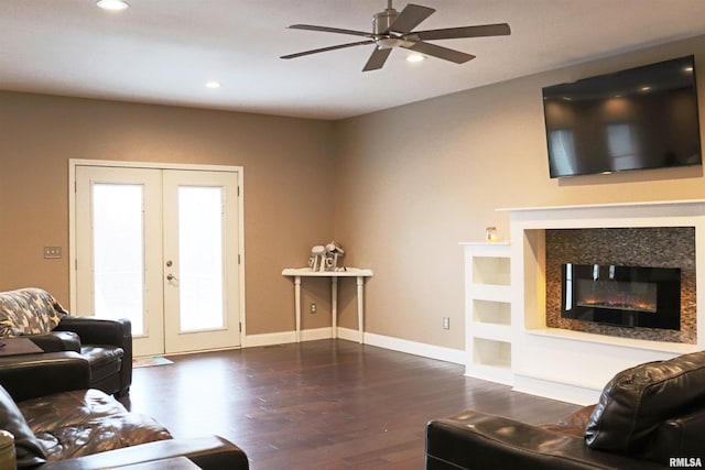 living room featuring ceiling fan, dark wood-type flooring, and french doors