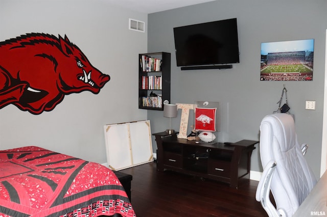 bedroom with dark hardwood / wood-style flooring