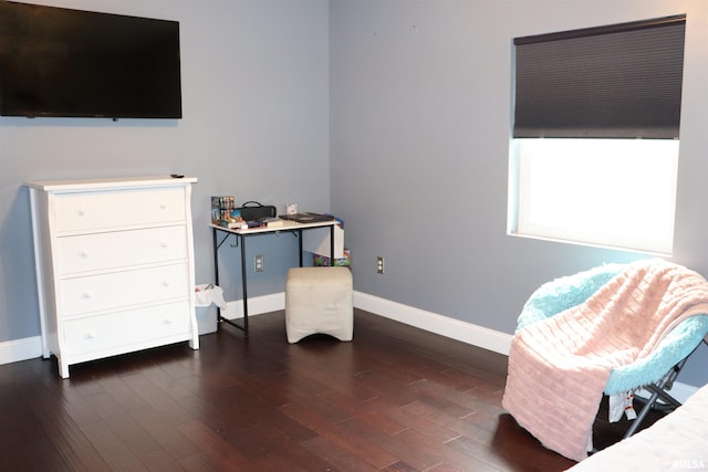 sitting room with dark wood-type flooring