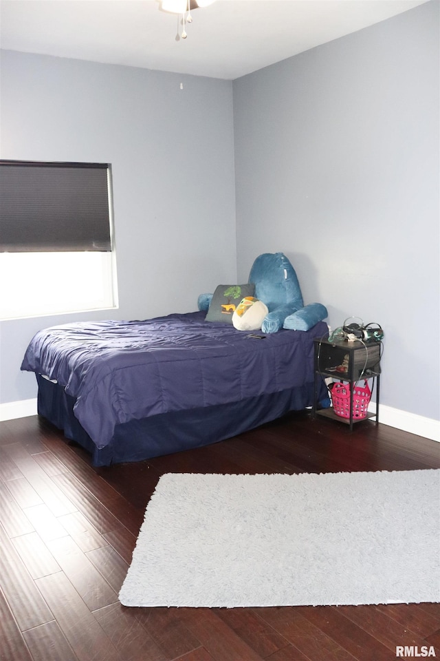 bedroom with dark hardwood / wood-style floors