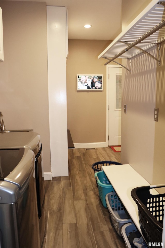 washroom featuring dark wood-type flooring and washing machine and clothes dryer