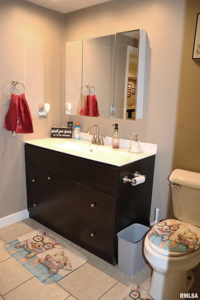 bathroom with tile patterned flooring, vanity, and toilet