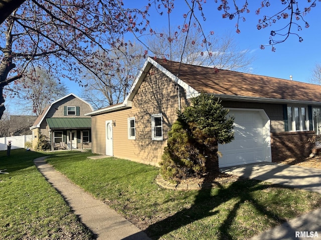 view of side of home featuring a lawn, a porch, and a garage