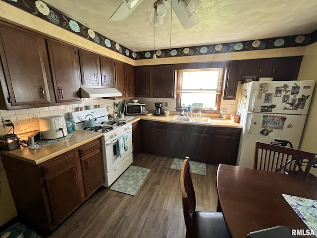 kitchen with white appliances, ceiling fan, dark wood-type flooring, exhaust hood, and sink