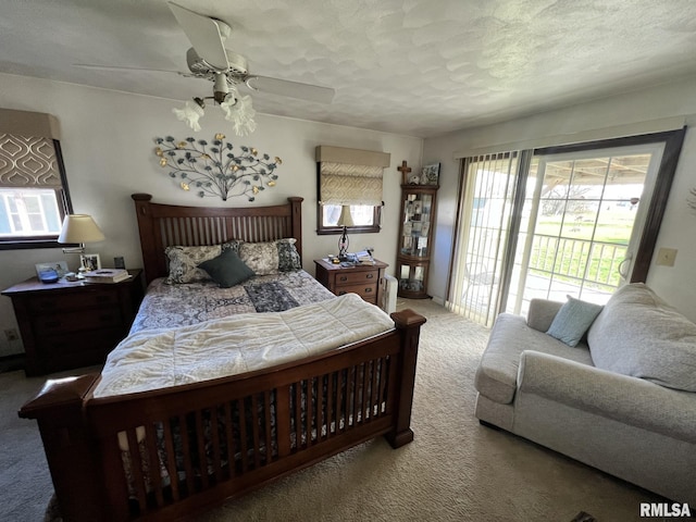 carpeted bedroom with ceiling fan and a textured ceiling