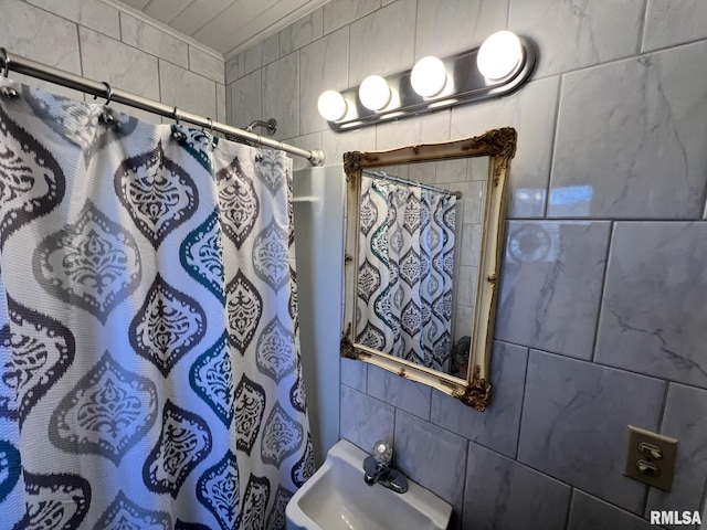 bathroom featuring a shower with curtain and tile walls