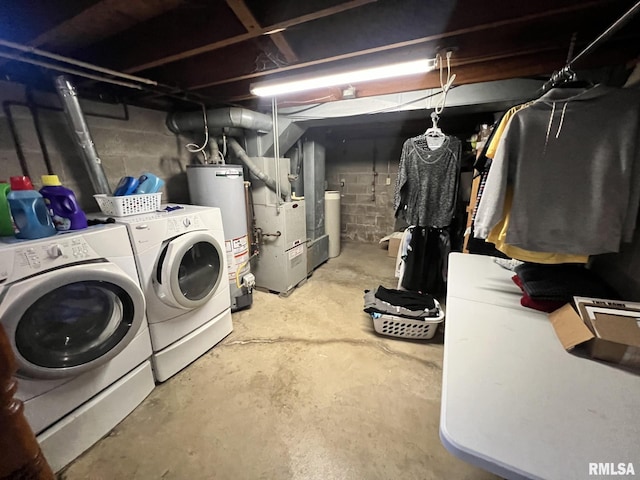 clothes washing area with washing machine and dryer, gas water heater, and heating unit