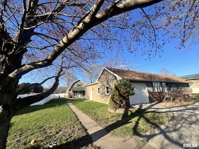 view of side of home with a lawn and a garage