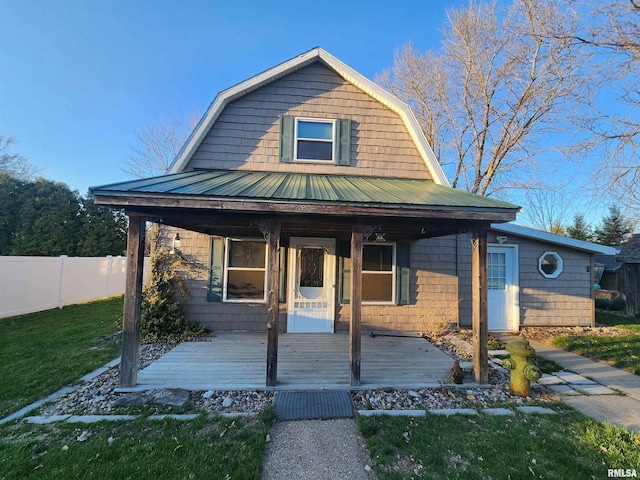 view of front of property with a porch and a front yard