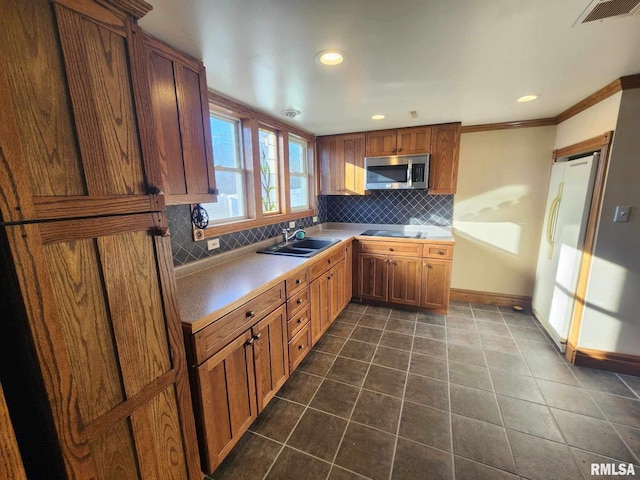 kitchen with decorative backsplash, black cooktop, ornamental molding, and sink