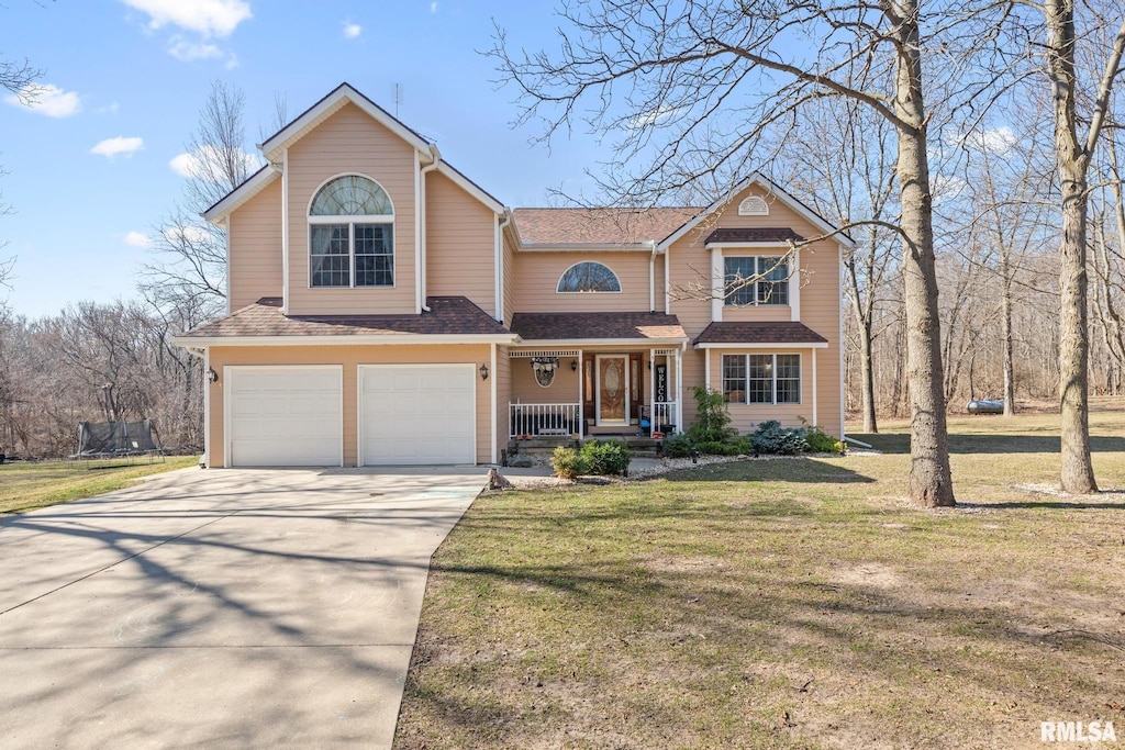 front facade with a trampoline, a garage, a front lawn, and a porch