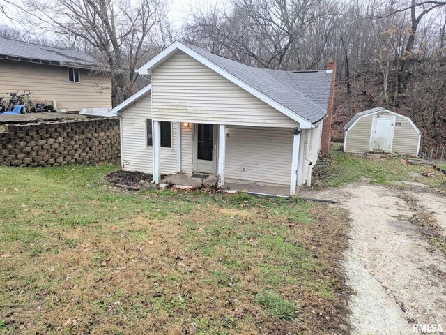 ranch-style home featuring a shed and a front yard