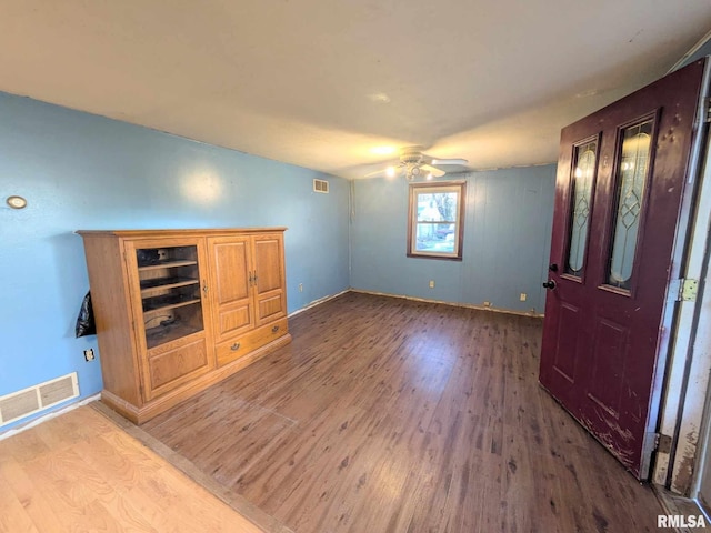 unfurnished living room featuring hardwood / wood-style flooring and ceiling fan