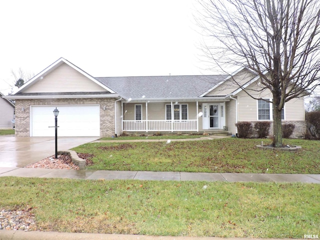 ranch-style home featuring a front yard, a garage, and covered porch